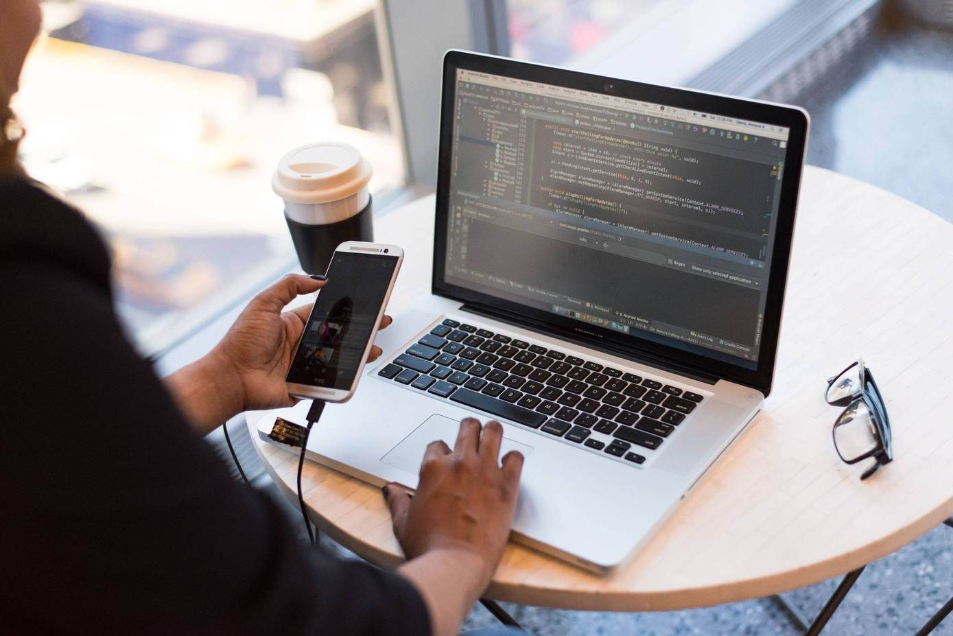 Developers reviewing code together at an office workstation